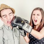 Man and woman boxing with gloves.