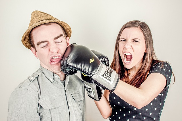 Man and woman boxing with gloves.