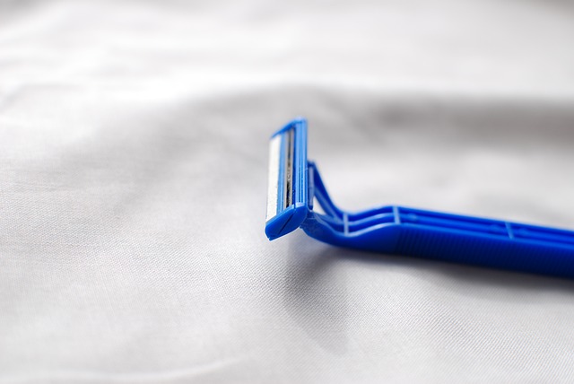 A blue razor blade on white cloth.