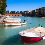 Boats docked near building on water.