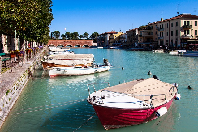 Boats docked near building on water.