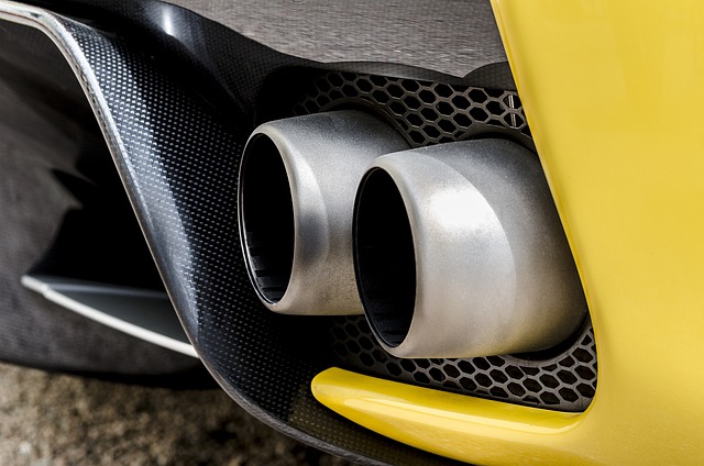 The exhaust pipes of a bright yellow sports car.