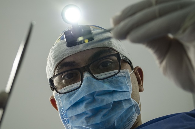 Surgeon holding a light in hand during surgery.