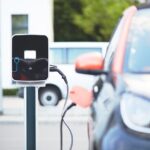 Electric car plugged into charging station.