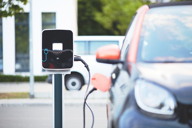 Electric car plugged into charging station.