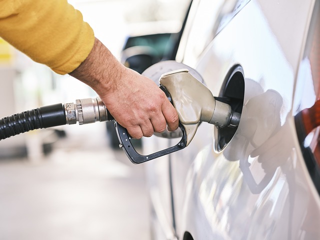 A person fueling up their car at a gas station.