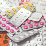 Various pills and tablets spread out on a table.