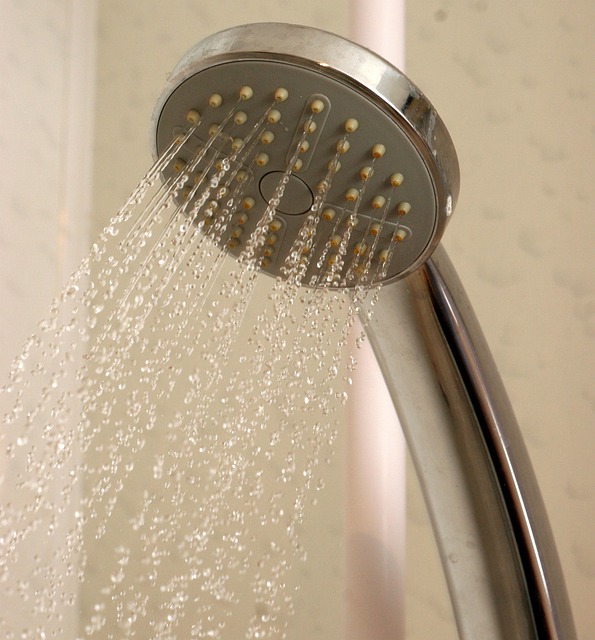 A shower head spraying water.