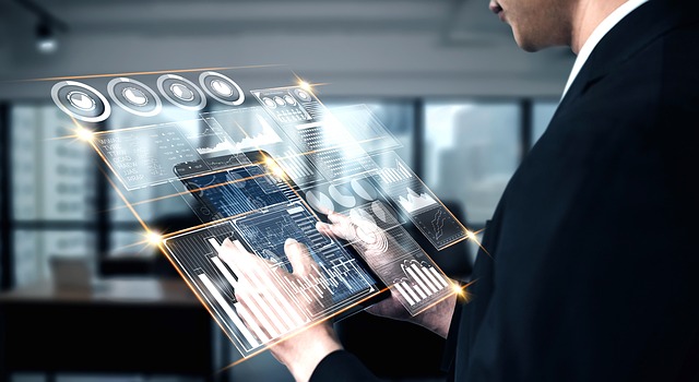 A man in a suit holding a tablet with a digital interface.