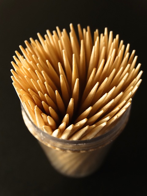 Container filled with wooden toothpicks.