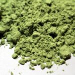 Finely ground green matcha powder, ideal for tea, is known for its vibrant color and health benefits.