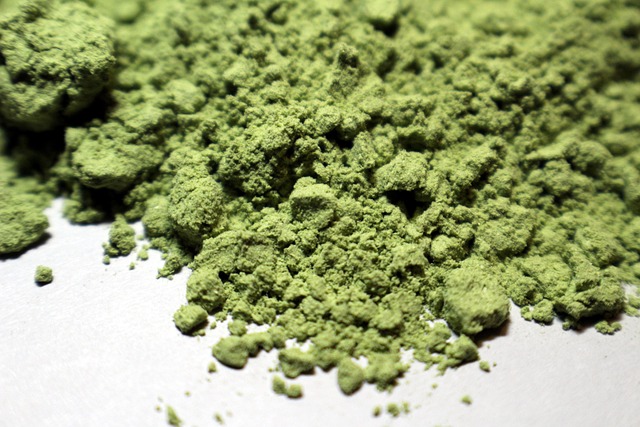 Finely ground green matcha powder, ideal for tea, is known for its vibrant color and health benefits.